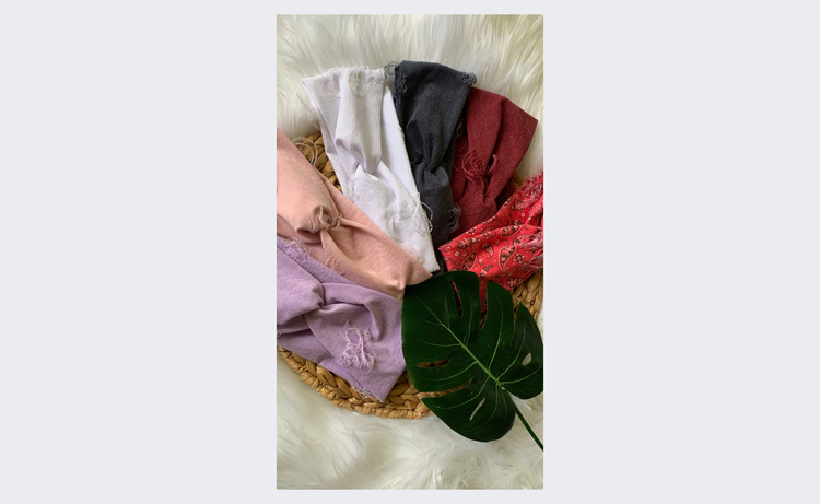 headbands with rips in them around a monstera leaf as a photo prop