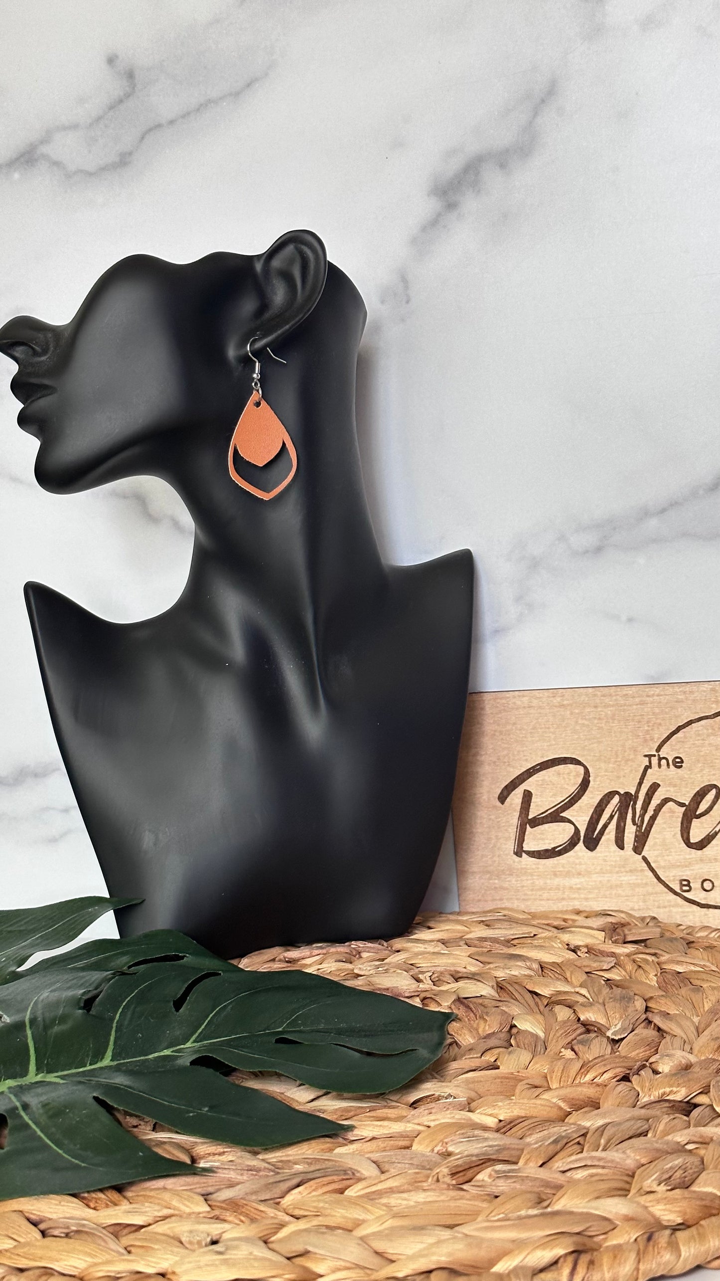 Cognac curved faux leather earring.
