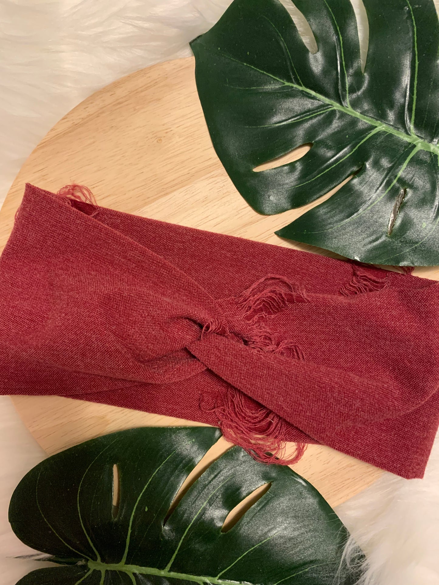 Photo of a red distressed or tattered twist headband.