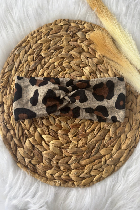 A leopard print headband on a heather background